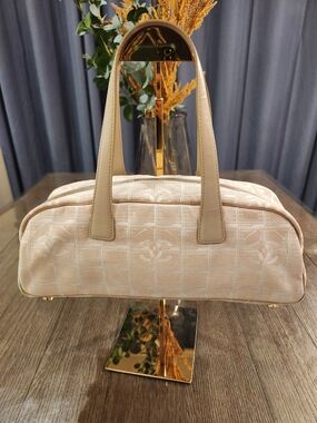 CHANEL
Nylon Travel Bowler Beige